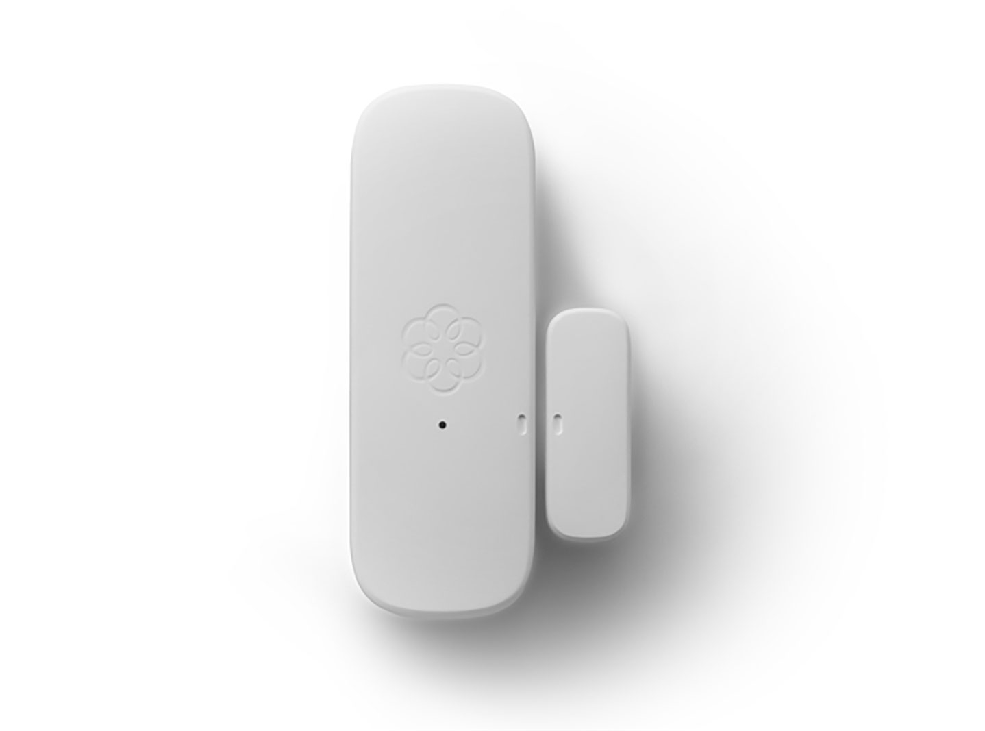 Door and window sensor used in home security with black and white backdrop.